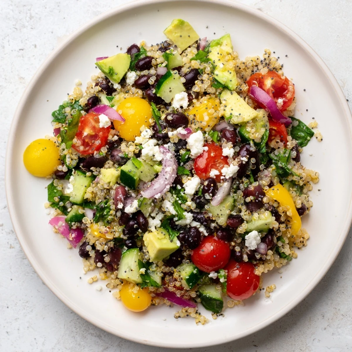 Vibrant Poppy-Bright Colorful Quinoa and Black Bean Salad, full of crisp veggies and a poppy seed dressing.