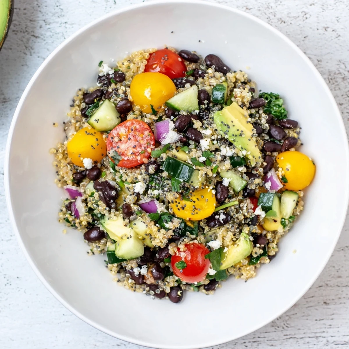 This colorful Poppy-Bright Colorful Quinoa and Black Bean Salad looks cool, with chopped vegetables and beans.