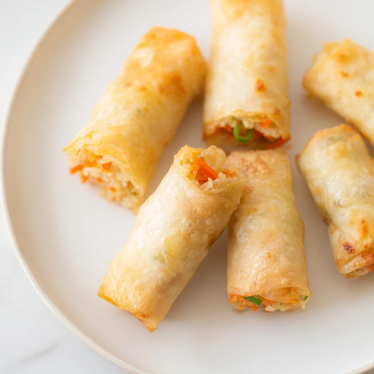 Golden-brown air fryer chicken lumpia bites, a crispy Filipino snack, ready to be dipped.