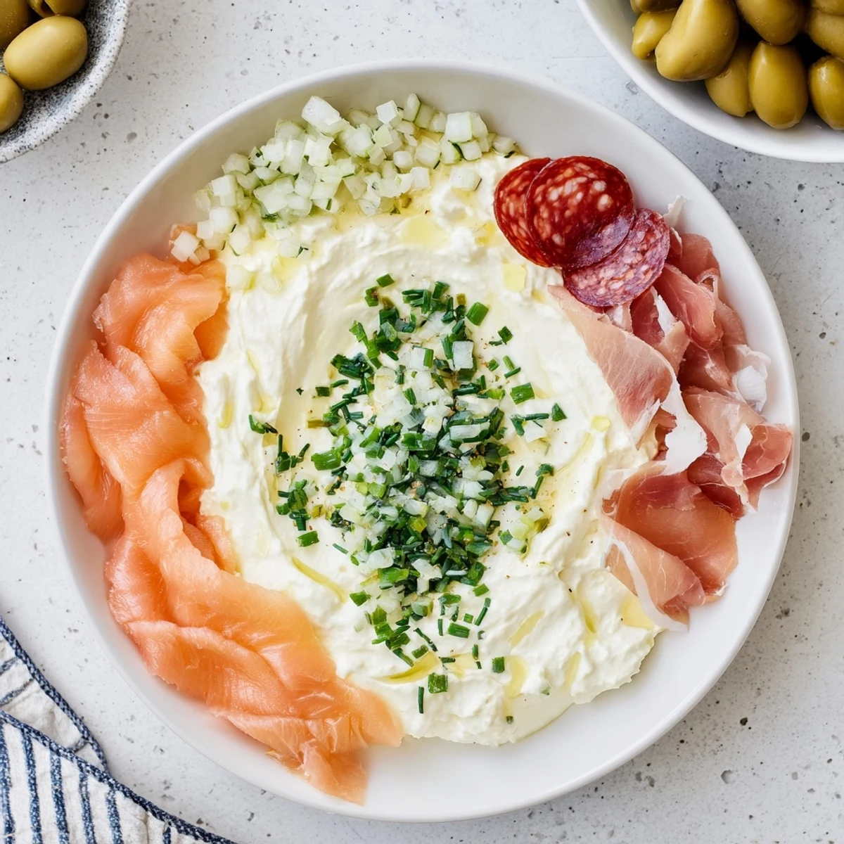 The visually stunning "Compass Rose" features colorful meats surrounding a creamy dip, perfect for sharing.