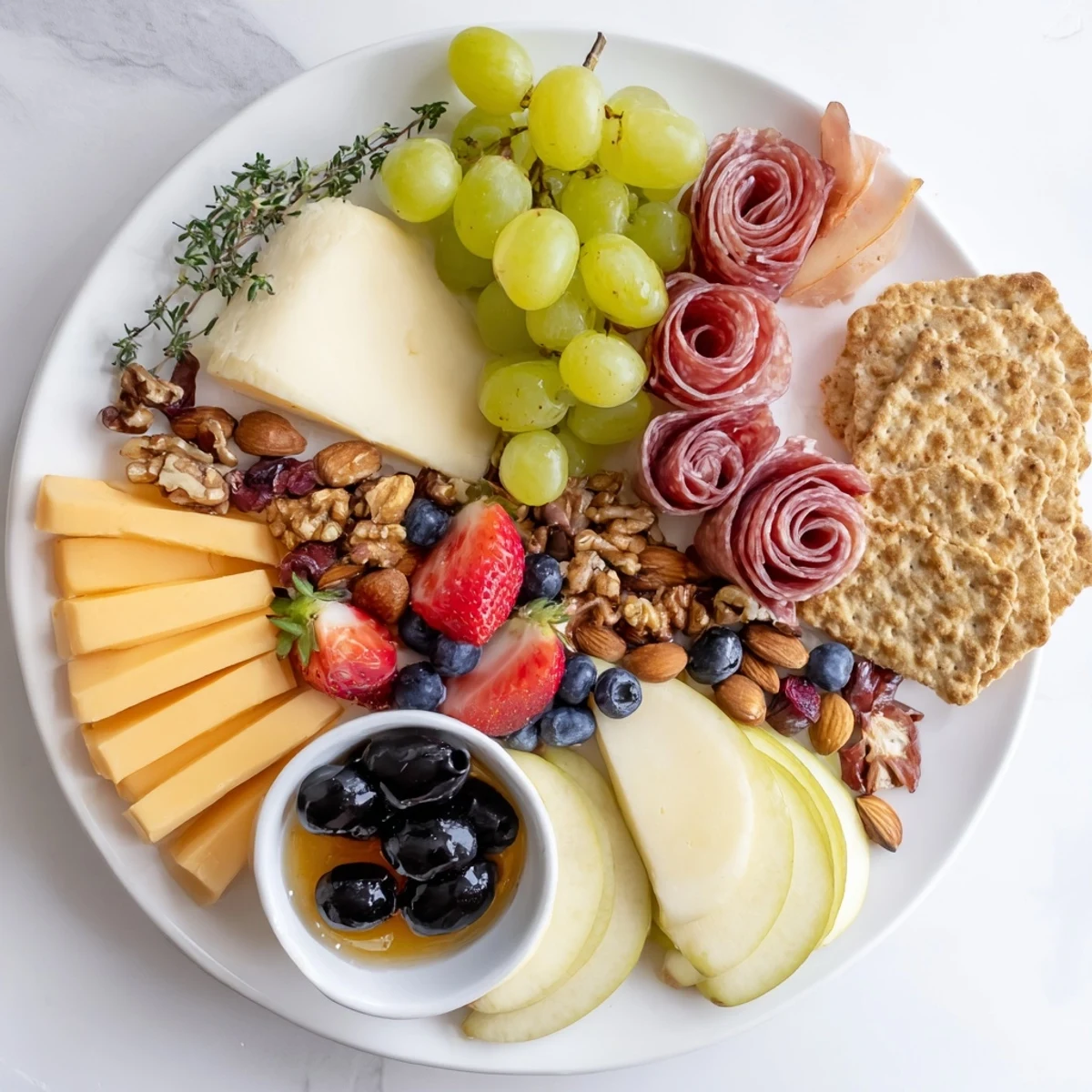 A beautifully arranged Quick Charcuterie Snack Board, showcasing vibrant cheese, meats, and fresh fruits.