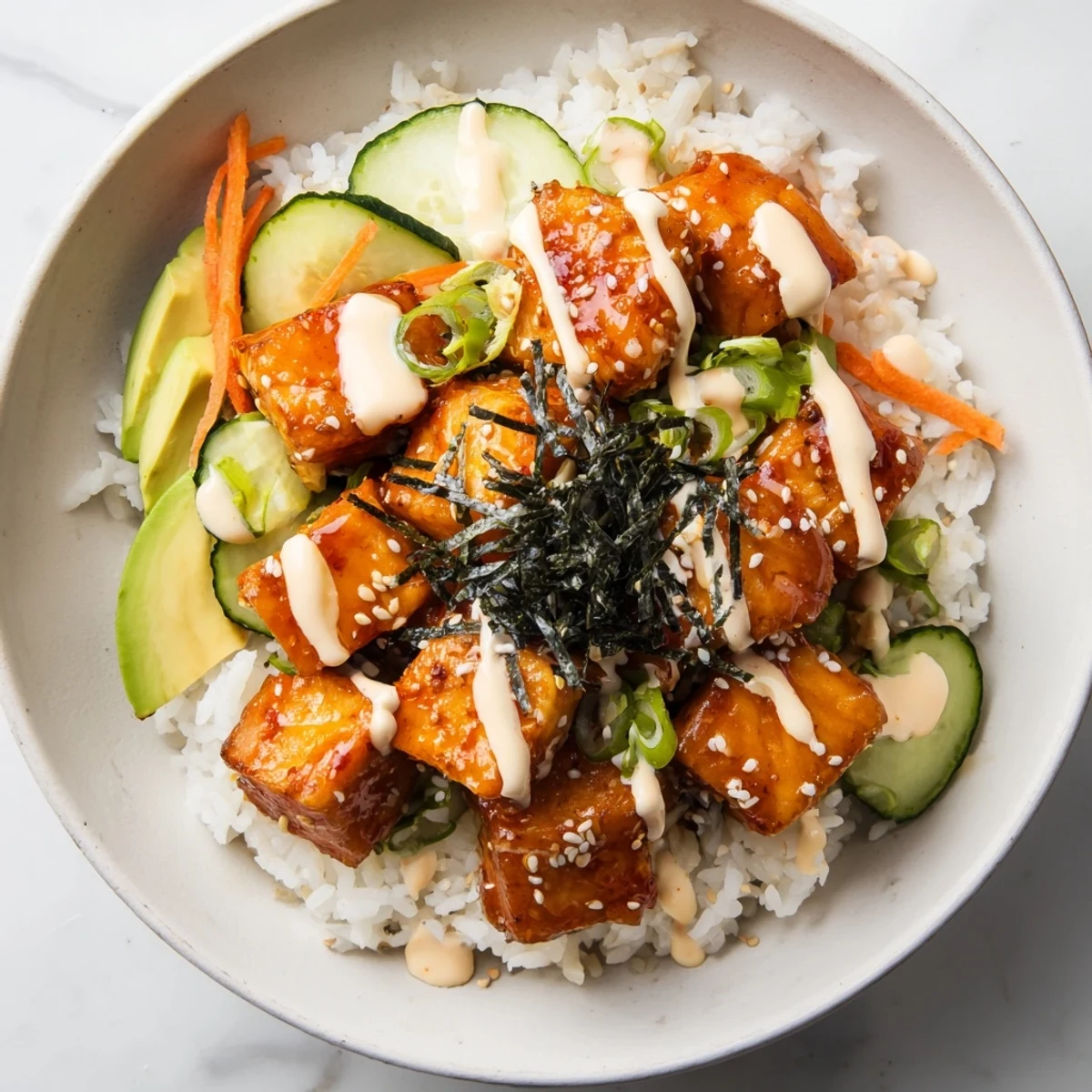Golden-brown salmon bites atop rice, a colorful Salmon Bites Bowl with fresh vegetables.