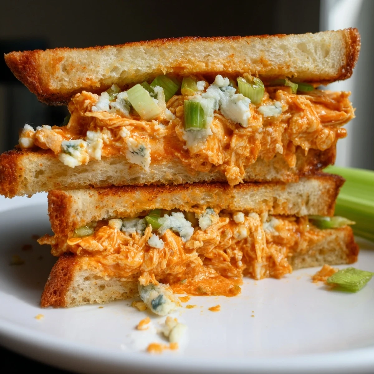 A close-up of a perfectly toasted Buffalo Chicken Grilled Cheese, ready to be sliced and devoured.