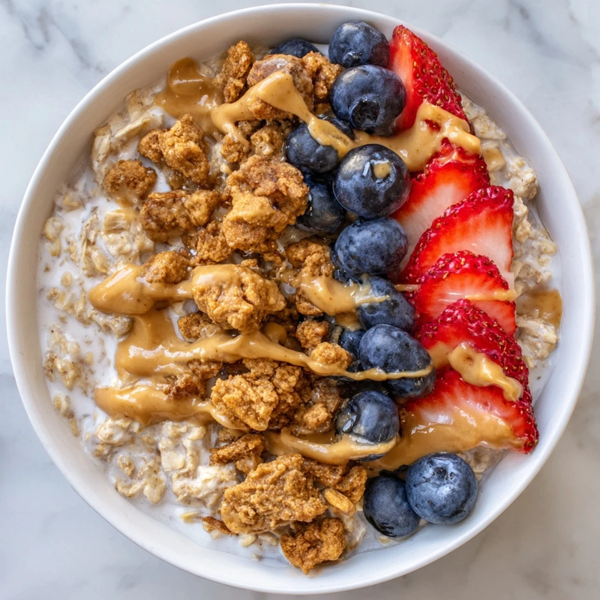 Creamy Overnight Oats Gourmet Makeover topped with fresh berries and nut butter swirls looks delicious.