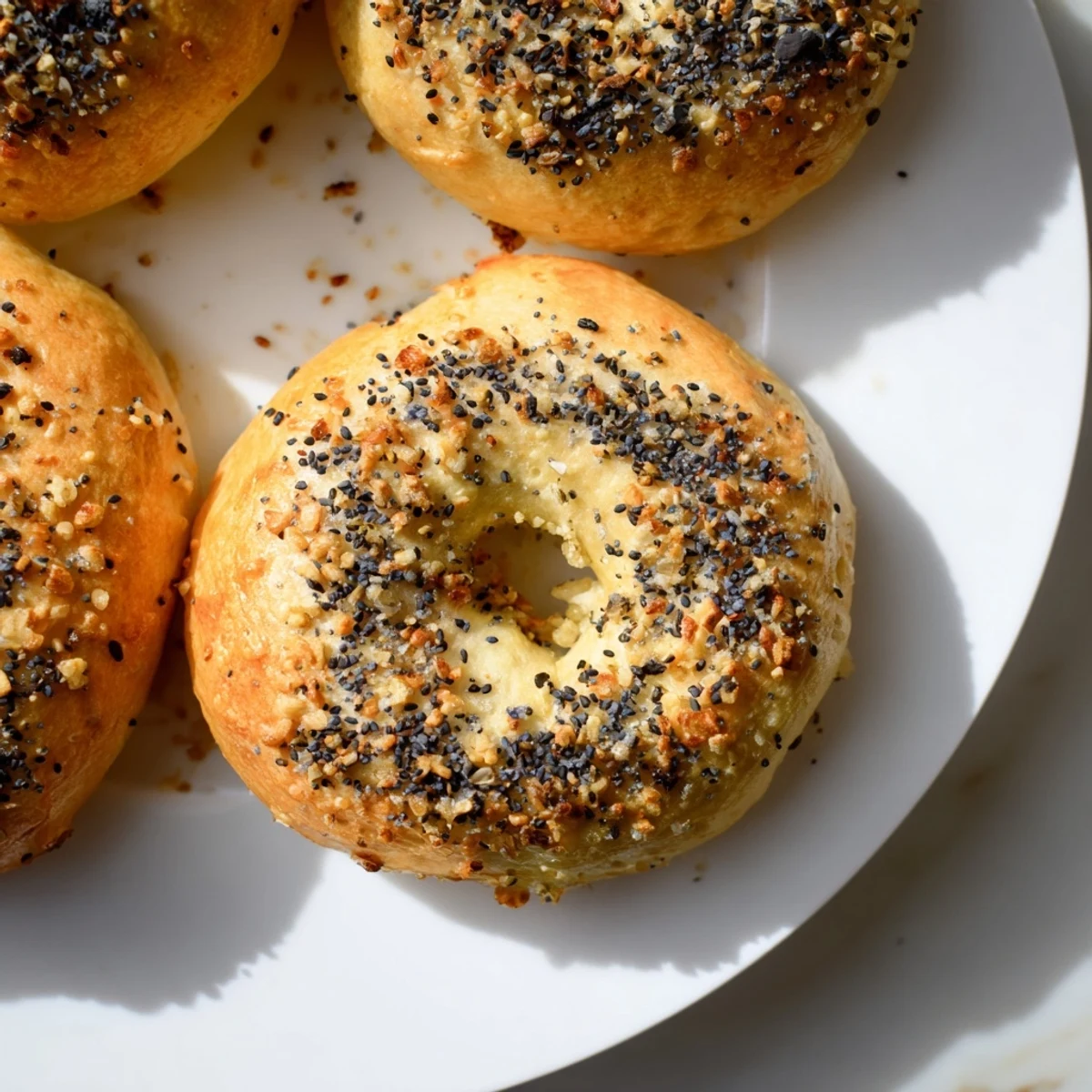 Enjoy a stack of homemade everything bagel yogurt bagels, warm from the oven with a delicious, savory aroma.