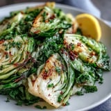 Tender cabbage and red onion tossed with cumin and paprika, finished with parsley in a warm skillet for an easy side.