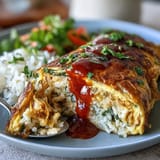 Savory ketchup rice ensconced in a cloud-like omelet, ready to be enjoyed.
