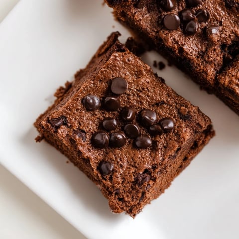 Fudgy Greek yogurt brownies, warm from the oven, with a crackly top, ready for enjoying.