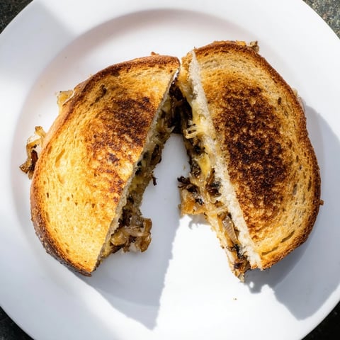 Toasted country bread holds melted Gruyère and sweet, slow-cooked caramelized onions in this gourmet grilled cheese.