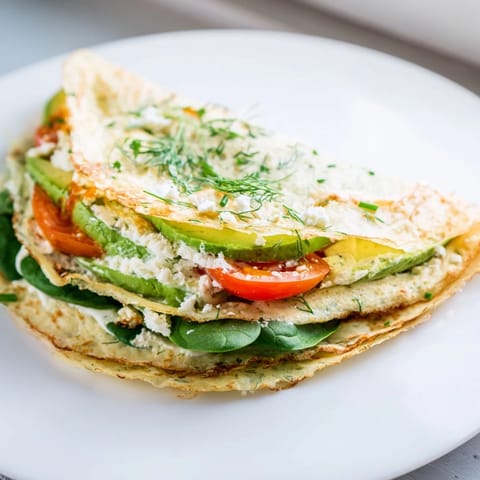 A freshly made Blender-Egg Crepe Wrap, thin and delicate, showing the layered fillings inside perfectly.