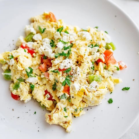 Savory Turkish Menemen, a colorful skillet breakfast with soft scrambled eggs, and fresh, simmered tomatoes.