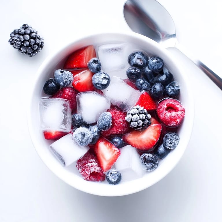 A colorful, hydrating Natures Cereal Bowl garnished with fresh berries and crisp ice cubes.  
