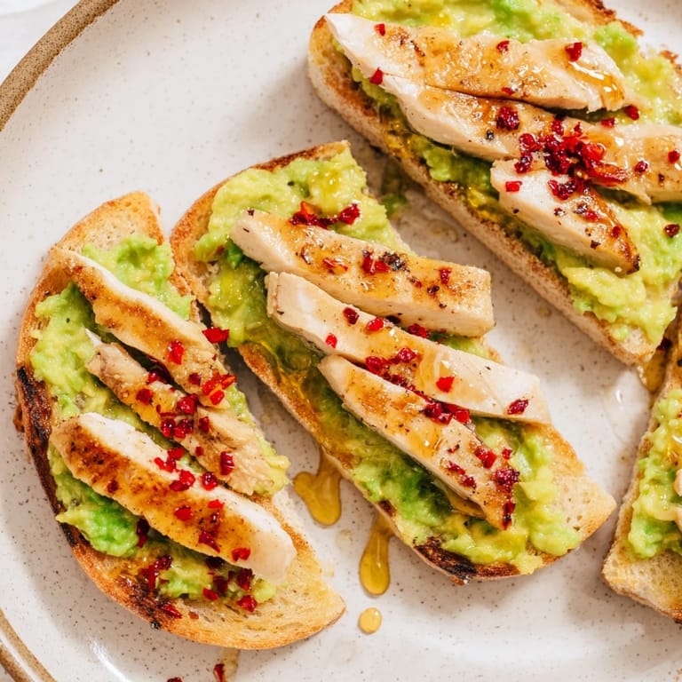 Crunchy multigrain toast topped with savory grilled chicken and bright lemon-avocado mash, finished with a spicy-sweet drizzle.