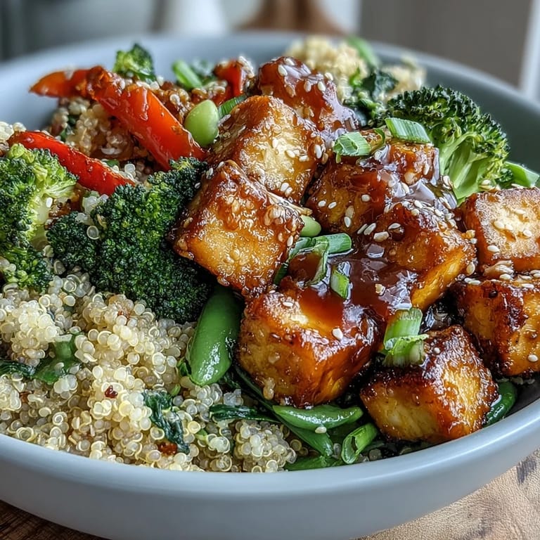 A wholesome Quinoa Vegetable Teriyaki Bowl garnished with sesame seeds and sliced green onions, perfect for a vegan weeknight meal.